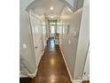 Inviting hallway featuring hardwood floors, neutral walls, and multiple doors leading to various rooms at 2752 Sawbridge Ln, Gastonia, NC 28056