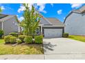 Attractive home showcasing a two-car garage, well-maintained lawn and landscaping, and lovely curb appeal at 3022 Oakmere Rd, Waxhaw, NC 28173