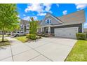 Beautiful home with a two-car garage, expansive driveway, nice landscaping, and a welcoming front porch at 3022 Oakmere Rd, Waxhaw, NC 28173