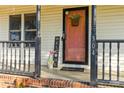 Welcoming front porch with flowers, 'WELCOME' sign, and house number 304 by the door at 304 W Fourth St, Cherryville, NC 28021