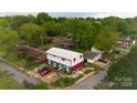 Bird's eye view of a two-story building with ample parking, surrounded by mature trees in a neighborhood setting at 310 4Th W St, Newton, NC 28658