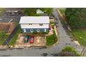 View from above of building's parking lot, with several cars, and street access, edged by landscaping and neighboring structures at 310 4Th W St, Newton, NC 28658