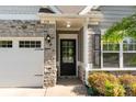 Charming home featuring a stone facade, a welcoming front door, and an attached white garage at 338 Livingston Dr, Lancaster, SC 29720