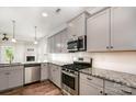 Modern kitchen featuring stainless steel appliances, gray cabinets, and beautiful granite countertops at 338 Livingston Dr, Lancaster, SC 29720