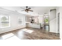 Bright and airy living room open to the kitchen, featuring wood floors and abundant natural light at 338 Livingston Dr, Lancaster, SC 29720