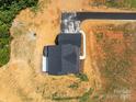 Birds eye view of a modern farmhouse with a newly installed driveway at 4040 Daugherty Rd, China Grove, NC 28023
