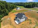 Aerial view of a modern farmhouse on a large lot with a newly paved driveway at 4040 Daugherty Rd, China Grove, NC 28023