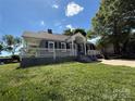 Charming single-story home with a welcoming front porch and well-maintained landscaping, offering classic curb appeal at 406 S Catawba St, Lancaster, SC 29720