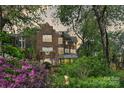 Charming exterior view of the brick home surrounded by lush greenery at 423 N Pine St, Charlotte, NC 28202