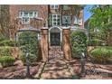 The home features an iron gate leading to the front entrance with a brick pathway at 423 N Pine St, Charlotte, NC 28202