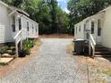 View of backyard area, showing gravel and the exteriors of both homes at 424 Skyland Ave, Charlotte, NC 28205