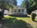 Charming one-story home with a welcoming front porch and green lawn at 424 Skyland Ave, Charlotte, NC 28205