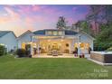 Inviting backyard featuring a covered patio with ample seating and a built-in grill at 5490 Sapwood Ct, Denver, NC 28037