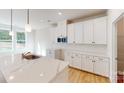 Bright kitchen featuring white cabinets, stainless steel appliances, and a large center island at 604 Banter Ln # 29, Cramerton, NC 28032