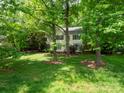 View of house situated on a spacious lot, surrounded by mature trees, offering privacy at 6100 Hunter Ln, Weddington, NC 28104