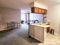 Inviting living room and kitchen combo featuring bar seating and neutral tones at 6234 Rosecroft Dr, Charlotte, NC 28215
