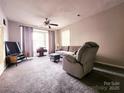 Relaxing living room with plush seating and a large window offering natural light at 6234 Rosecroft Dr, Charlotte, NC 28215