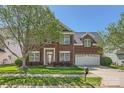 Beautiful two-story brick home featuring manicured lawn, mature trees, and a wide driveway at 639 Lorain Nw Ave, Concord, NC 28027