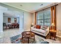 Inviting living room featuring neutral tones, tiled floor, and view to dining area at 639 Lorain Nw Ave, Concord, NC 28027