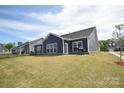 Backyard featuring a well maintained yard with large windows at 705 Hinterland Ln, Matthews, NC 28104