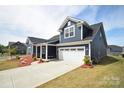 Home featuring an attached two-car garage and a wide driveway at 705 Hinterland Ln, Matthews, NC 28104