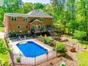 Serene backyard features a sparkling pool, spacious deck, and lush garden area at 7122 Forest Ridge Rd, Matthews, NC 28104