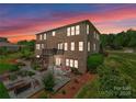 Spacious backyard features a patio with a fire pit and outdoor seating, a deck and landscaped grounds at 733 Lingfield Ln, Waxhaw, NC 28173