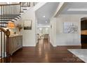 Elegant foyer with hardwood floors, decorative wainscoting and trim with a view to the living room at 733 Lingfield Ln, Waxhaw, NC 28173