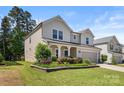 Beautiful two-story home with landscaped yard and charming architectural details at 9849 Steele Meadow Rd, Charlotte, NC 28273