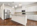 Modern kitchen with white cabinets, stainless steel appliances, and granite countertops at 9849 Steele Meadow Rd, Charlotte, NC 28273