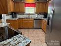 Well-equipped kitchen with granite countertops, stainless steel appliances, and tile flooring at 1025 Bee Line Ln, Salisbury, NC 28147