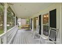 Inviting screened-in porch with rocking chairs and a porch swing at 105 Horsestable Ct, Mooresville, NC 28115
