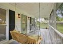 Cozy porch with rocking chairs and a swing, perfect for relaxing at 105 Horsestable Ct, Mooresville, NC 28115
