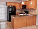 Kitchen with stainless steel appliances, wooden cabinets, and island at 1156 Fowler Brook Ct, Indian Land, SC 29707