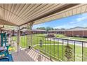 Balcony view overlooking a lush green lawn, pool, and neighboring buildings in a serene setting at 123 Carriage House Dr, Kannapolis, NC 28081