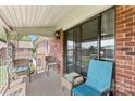 Relaxing balcony space with wicker chairs and a view of the brick building at 123 Carriage House Dr, Kannapolis, NC 28081