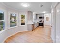 Modern kitchen with stainless steel appliances, white subway tile backsplash, and elegant gray cabinets at 12620 Sulgrave Dr, Huntersville, NC 28078