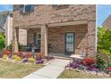 Welcoming front porch with seating and colorful flowers, offering a cozy curb appeal at 1316 Colgher St, Mint Hill, NC 28227