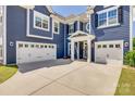 Three-car garage with white doors and ample driveway space for parking at 14925 Baldridge Dr, Huntersville, NC 28078