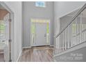 A bright entryway that features a beautiful front door, a transom window and side windows at 156 Pecan Hills Dr, Mooresville, NC 28115