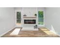Modern fireplace with shiplap and decor in a naturally lit living space at 1640 English Knoll Dr, Matthews, NC 28105