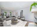 Cozy living room featuring a comfortable seating area and view into the dining area and natural light at 1640 English Knoll Dr, Matthews, NC 28105