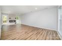 Bright living room with wood-look floors and a modern fireplace feature wall at 1640 English Knoll Dr, Matthews, NC 28105