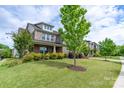 A well-maintained lawn and neatly trimmed bushes highlight the house's exterior at 16711 Monocacy Blvd, Huntersville, NC 28078