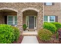 Inviting front entrance features a stone archway and beautiful landscaping at 1737 Cavaillon Dr, Waxhaw, NC 28173