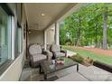 Relaxing outdoor living space with comfortable seating, a ceiling fan, and a view of the lush backyard at 20614 Pointe Regatta Dr, Cornelius, NC 28031