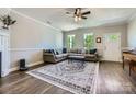 Cozy living room with modern ceiling fan, large sectional sofa, and ample natural light at 2206 Mills Harris Rd, Wingate, NC 28174