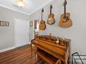 Inviting entryway featuring hardwood floors, a charming piano, and decorative guitars hanging on the wall at 2225 Corinth Church Rd, Monroe, NC 28112