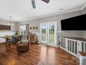Open concept living room featuring hardwood floors, a flat screen TV, and French doors to the backyard at 2225 Corinth Church Rd, Monroe, NC 28112