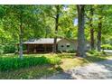 Charming home exterior with a covered porch, wood columns, and lush greenery at 237 Fea Ln, Iron Station, NC 28080